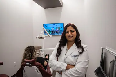 Dr. Jaiswal of Starlite Dental posing in her dental exam room