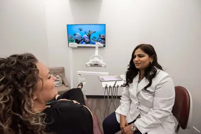 Dr. Jaiswal discussing cosmetic dentistry options with one of her patients