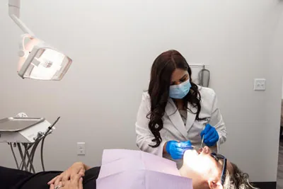 Dr. Jaiswal performing an emergency dental procedure on a patient at Starlite Dental