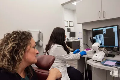 Dr. Jaiswal showing a patient their periodontal issues through x-rays