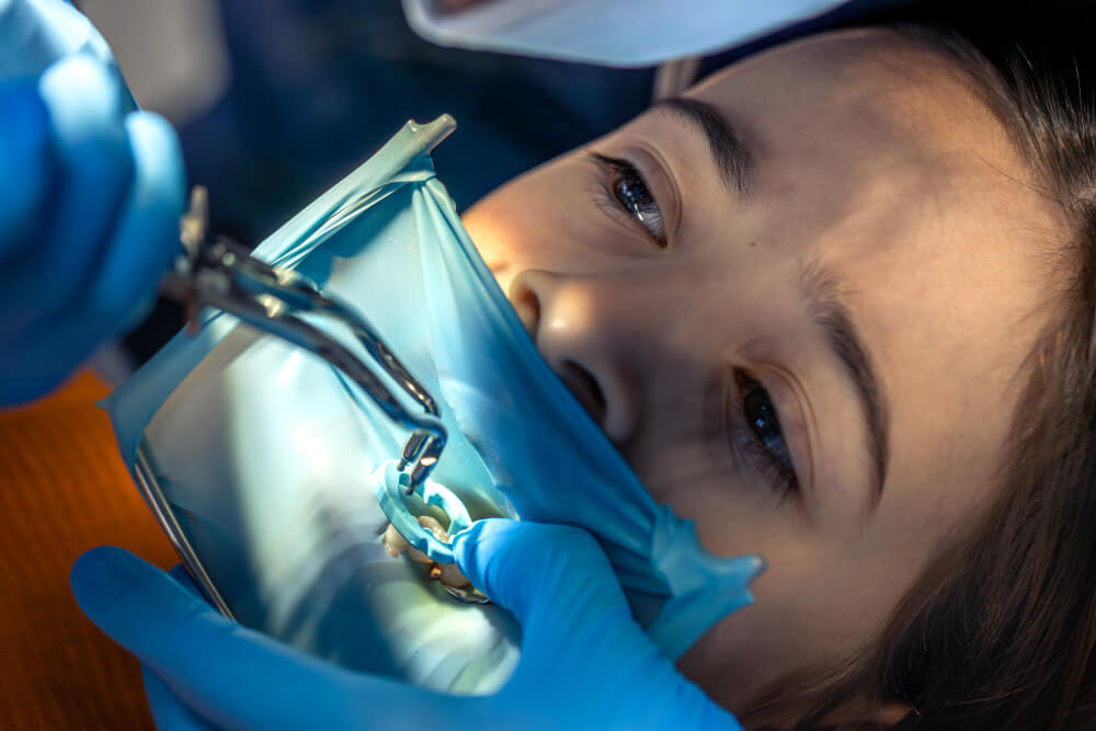 image of a young kid undergoing a dental procedure