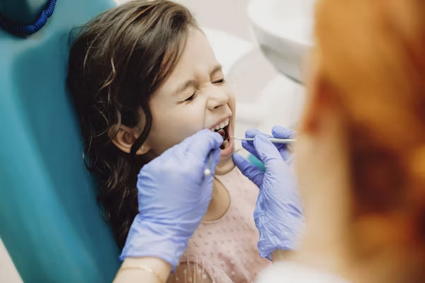 a photo showing a kid during a dental treatment