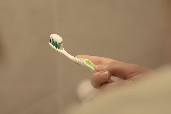 a toothbrush with tooth paste on it