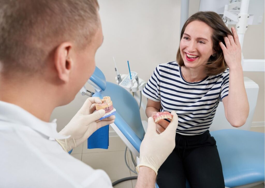 Dentist discussing dental implant costs and treatment options with a patient during a consultation