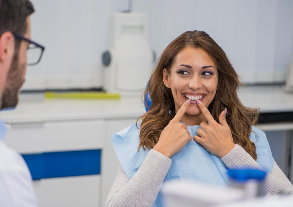 Patient discussing veneer care and maintenance tips during a porcelain veneer follow-up dental visit