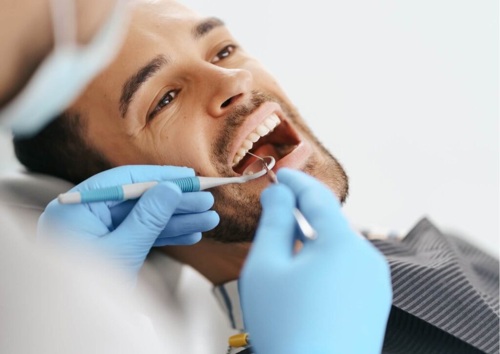 Patient receiving a dental exam that highlights the importance of the mouth-body connection and overall oral health