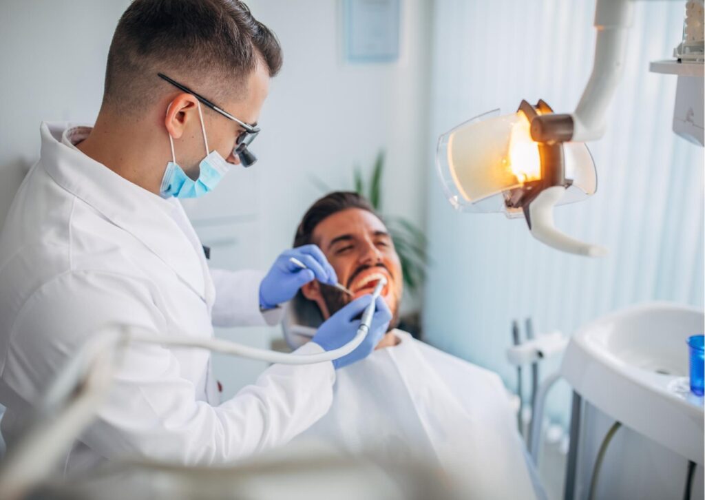 Dentist examining a patient's wisdom tooth to monitor its development and determine whether it is coming in properly.