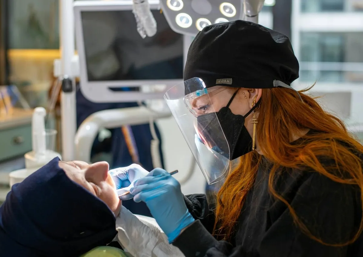 Dental professional providing implant care as part of an affordable dental implant treatment plan.